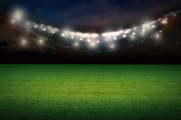 empty football field with stadium at night © phonlamaiphoto