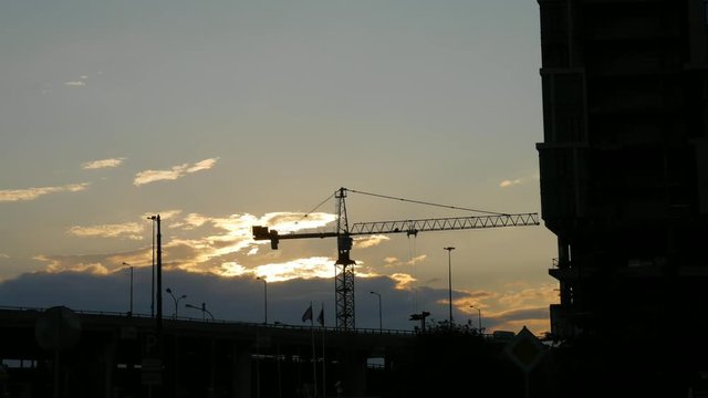High tower crane on a construction site, timelapse