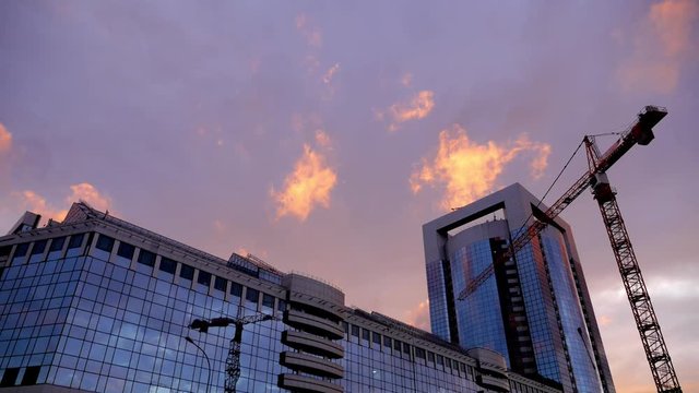 Building tower crane with sunset sky at the background. Moscow, Russia Federation, timelapse