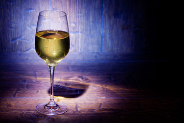 Wine glass on blue wooden background
