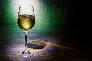 Wine glass on green wooden background