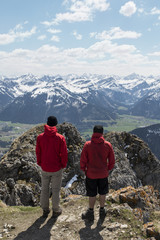 Fototapeta na wymiar two hikers enjoying the view over the alps