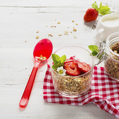 strawberry yogurt with muesli on a old wooden background