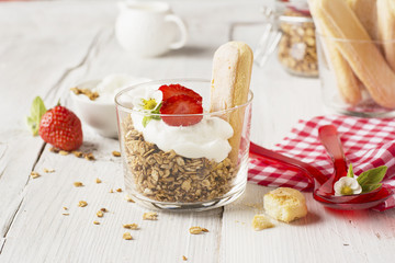 strawberry yogurt with muesli on a old wooden background