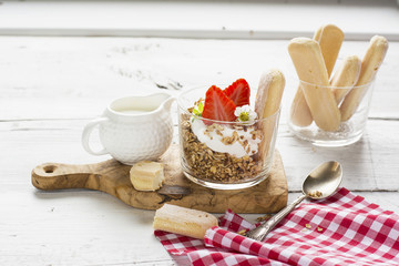 strawberry yogurt with muesli on a old wooden background