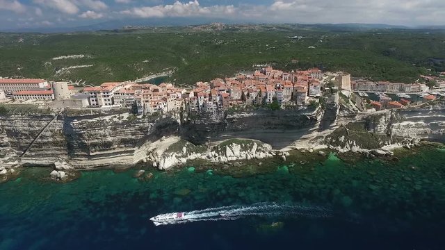 Aerial: Flight over historical citadel of Bonifacio, harbour on South Corsica island, France, Europe 