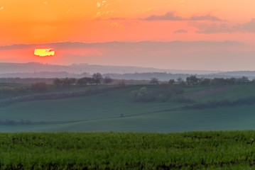 Beautiful sunrise above misty hills