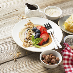 Oatmeal pancakes in a frying pan on wooden table