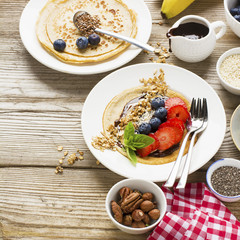 Oatmeal pancakes in a frying pan on wooden table