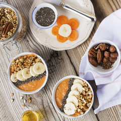 Healthy breakfast. Carrot Banana smoothie with granola and chia seeds