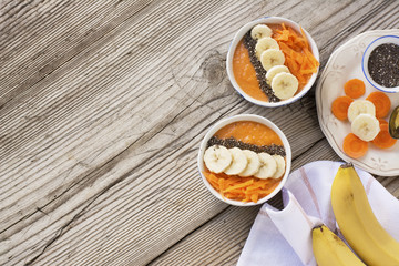 Healthy breakfast. Carrot Banana smoothie with granola and chia seeds