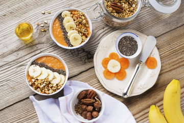 Healthy breakfast. Carrot Banana smoothie with granola and chia seeds