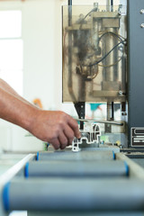 Manual worker assembling PVC doors and windows. Manufacturing jobs. Selective focus. Factory for aluminum and PVC windows and doors production.