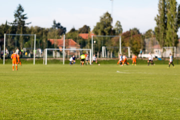 Fototapeta na wymiar Blurred soccer players playing amateur soccer match