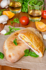 Calzone pizza with ham , mushrooms and corn