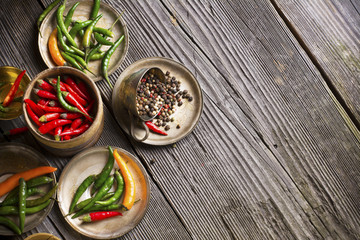 Hot peppers and spices on a dark wooden background