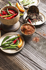 Hot peppers and spices on a dark wooden background