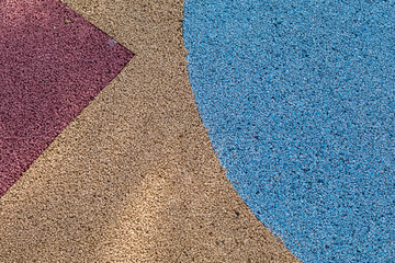 Colorful red, yellow and blue Rubber Wetpour playground floor surface.