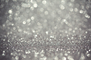 Silver glitter bokeh background. Shiny holiday background. Wallpaper for web design