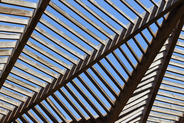 The roof is wooden arbor against the blue sky