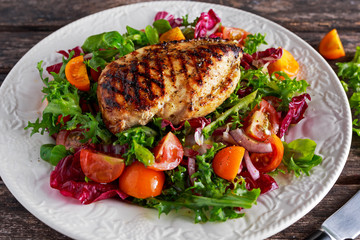 Grilled Chicken Breast fillet with fresh tomatoes vegetables salad. concept healthy food.