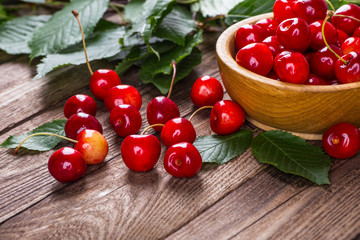 Fresh cherries in bowl on table