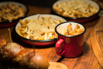 French fries in tin cups served with burgers