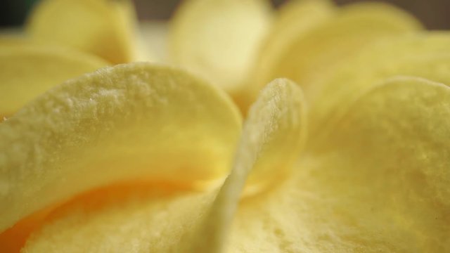 Potato chips on a rotating plate, close up video