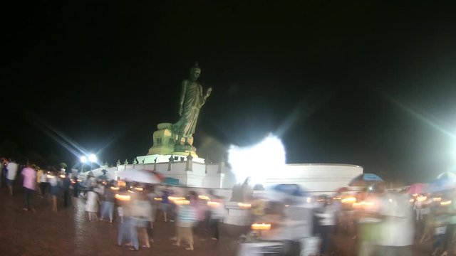 4K : People walk with candles around a large Buddha statue to celebrate Visakha Bucha Day