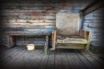 Old chair on the background of wooden wall.