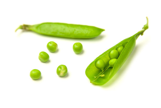 Pea pods and pea seeds on white