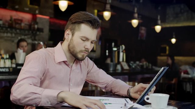 young business man is working in a bar