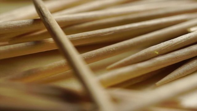 Pile of wooden toothpicks macro dolly shot