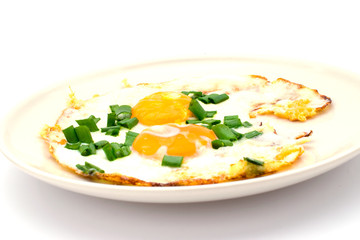 Two fried eggs with chives for healthy breakfast.