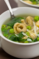 Tortellini Soup with Peas and Spinach. Selective focus.