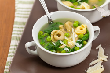 Tortellini Soup with Peas and Spinach. Selective focus.