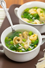 Tortellini Soup with Peas and Spinach. Selective focus.