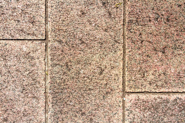 Fototapeta premium Red-tiled floor granite focused from above 