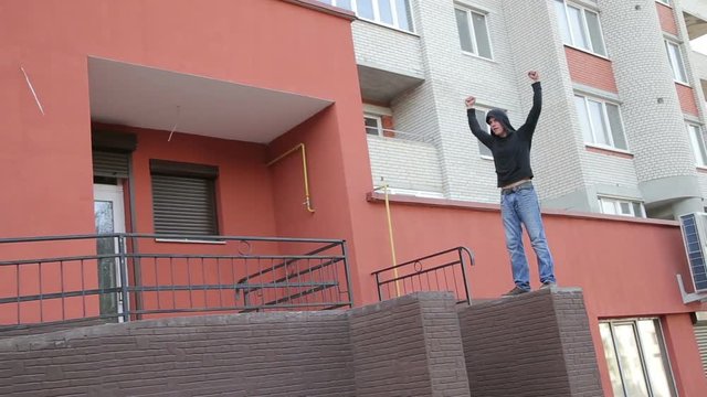 Street runner doing parkour over building stairs