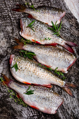 Fresh roach with fresh herbs on the board