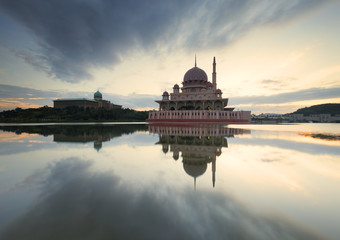 A reflection of clouds and mosque on a very calm morning.