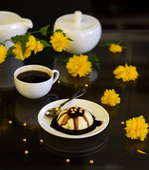 Panacotta - italian dessert with yellow flowers on dark background