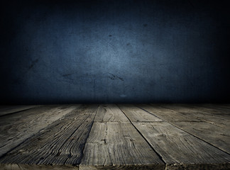 Rough wooden floor boards and blank blue textured wall. Copy space. Empty room