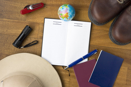 Travel concept - tourist accessories and open notebook with blank space fore design