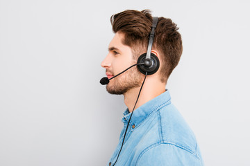 side view photo of  young agent of call-centre with headphones