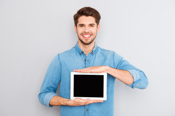 Man showing a blank digital tablet screen isolated on a gray bac