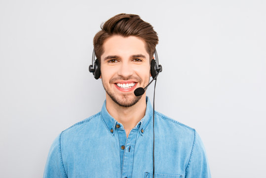 handsome young man in work in  call-centre with headphones and s