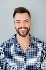 Fototapeta premium Portrait of handsome bearded young man with beaming smile