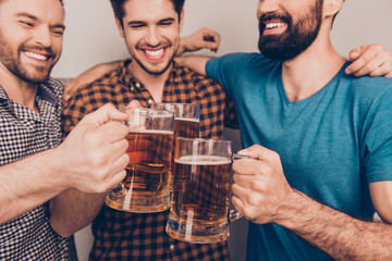 cheers! Close up photo of happy handsome men celebrating victory