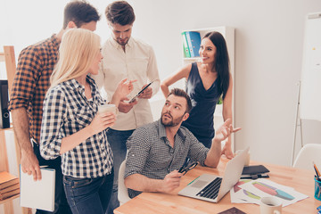 Young workers at a meeting have a cooffee-break